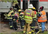  ?? RACHEL RAVINA — MEDIANEWS GROUP ?? First responders carry a person out of a SEPTA train Sunday morning during a simulated training exercise in downtown Lansdale.