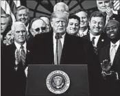  ?? CAROLYN KASTER/AP ?? President Donald Trump and Vice President Mike Pence, left, rejoice with GOP lawmakers after the bill’s passage.