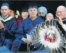  ?? JIM WELLS ?? Wrestling icon Bret Hart, centre, was among those receiving honorary degrees from Mount Royal University this week.