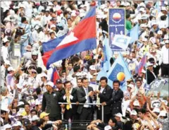  ?? STR/AFP ?? Ex-opposition leader Sam Rainsy (centre right, blue tie) and current CNRP leader Kem Sokha (centre left) greet supporters in Phnom Penh on the day of Rainsy’s return from self-imposed exile in 2013.