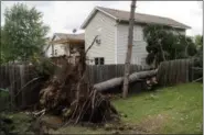  ?? NEIL BLAKE — THE GRAND RAPIDS PRESS VIA AP ?? A downed tree sits on a fence off of Prairie Parkway in Wyoming, Mich., Saturday after a reported tornado swept through the area. A storm that appeared to spawn at least one tornado slammed parts of western Michigan on Saturday, causing extensive...