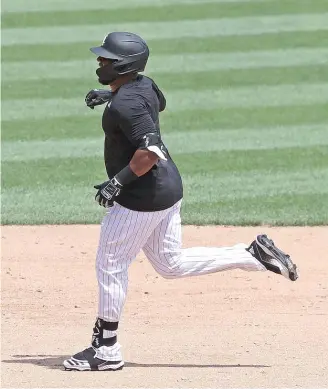  ?? JONATHAN DANIEL/GETTY IMAGES ?? Designated hitter Edwin Encarnacio­n runs the bases after hitting a solo home run during an intrasquad game at Guaranteed Rate Field on Thursday.