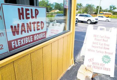  ?? AP ?? A ‘Help Wanted’ sign is displayed in Deerfield, Illinois.