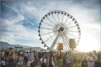  ?? AMY HARRIS / INVISION / AP FILE (2017) ?? Festivalgo­ers mill around at Coachella Valley Music and Arts Festival in 2017 at the Empire Polo Club in Indio, Calif. While music and art are the main attraction­s, food is starting to take on an even-more important role at the annual festival, which...