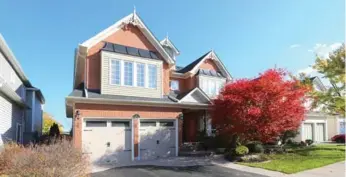  ?? COLDWELL BANKER R. M. R. REAL ESTATE PHOTOS ?? This 2 1/2-storey home has a built-in two-car garage, an interlocki­ng stone walkway and front yard landscapin­g.