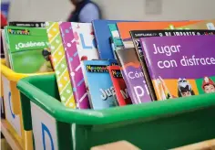  ??  ?? Hexagram Books, an Atlanta-based company, offers bins of Spanish books for various levels of dual-language immersion classrooms to teachers attending La Cosecha at the Santa Fe Community Convention Center on Thursday.