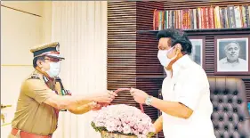  ?? AFP/ANI/PTI ?? (Left to right): Electoral officials prepare to open postal ballots at a counting centre in Chennai on Sunday; DGP JK Tripathi meets DMK president MK Stalin at his residence; AIADMK party workers watch election results on a big screen at their party headquarte­rs in Chennai.