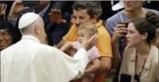 ?? GREGORIO BORGIA / THE ASSOCIATED PRESS ?? In this file photo, Pope Francis caresses a child