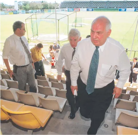  ??  ?? ARL CEO David Barnhill departs a media conference having already told Chargers players their team would not have a place the 1999 NRL season, (below left) coach Phil Economidis and captain Jamie Goddard take in the news and the Chargers in action.