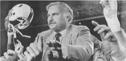  ?? AP ?? Howard Schnellenb­erger got a ride from his players after an upset of Nebraska in the Orange Bowl gave Miami the national title.