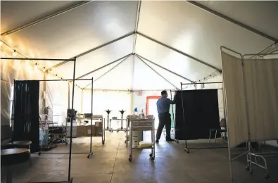  ?? Santiago Mejia / The Chronicle ?? The hospital tent at Santa Rosa Memorial Hospital is being set up for patients with less severe symptoms.