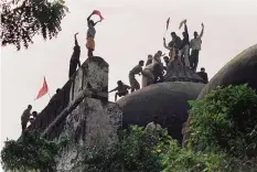  ??  ?? AYODHYA: This file photo taken on December 6, 1992 shows Hindu fundamenta­lists shouting and waving banners as they stand on top of a stone wall and celebrate the destructio­n of the 16th century Babri Mosque. —AFP