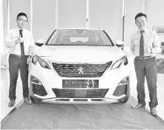  ??  ?? Lin (left) and Lim with the all-new Peugeot 5008 SUV.