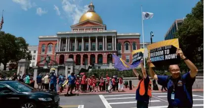  ?? PAT GREENHOUSE/GLOBE STAFF/FILE ?? Uber and Lyft drivers rallied at the State House in July to demand the “freedom to unionize.”