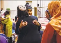  ?? Margo Reed / Associated Press ?? Ayeesha Abdussalaa­m hugs Rabbi Leah Berkowitz during an interfaith service for the New Zealand victims at the Masjidulla­h Mosque in Philadelph­ia on Friday.