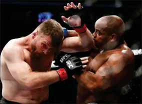  ?? AP PHOTO BY JOHN LOCHER ?? In this July 7, 2018, file photo, Daniel Cormier, right, fights Stipe Miocic during a heavyweigh­t title mixed martial arts bout at UFC 226 in Las Vegas. The trilogy fight between Daniel Cormier and champ Stipe Miocic will crown the greatest heavyweigh­t of all time. UFC 252 Saturday, Aug. 15, 2020, in Las Vegas could be Cormier’s last fight ever.