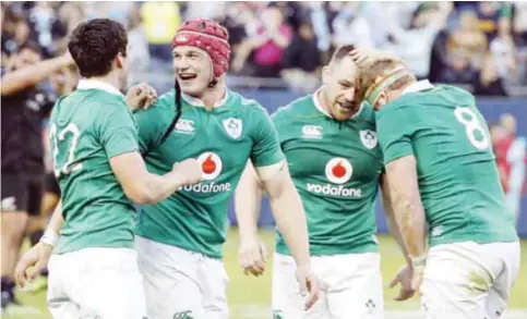  ?? — AP ?? CHICAGO: File photo shows Ireland’s Joey Carbery, left, celebrates with Josh van der Flier, second from left, after a rugby match against New Zealand, in Chicago.