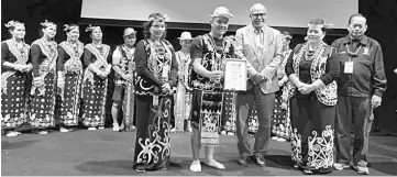  ??  ?? Robin (second left) accepts his award from Kanes, witnessed by (from left) Mujan and Elizabeth.