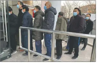  ?? (File Photo/AP/Ng Han Guan) ?? People line up Jan. 12 for covid-19 vaccinatio­ns in Beijing.
