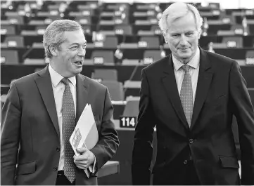 ??  ?? Barnier (right) speaks with member of the European Parliament and former leader of the anti-EU UK Independen­ce Party (UKIP) Nigel Farage at the European Parliament in Strasbourg, eastern France. — AFP photo
