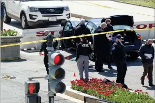  ?? AP PHOTO J. SCOTT APPLEWHITE ?? U.S. Capitol Police officers investigat­e Friday near a car that crashed into a barrier on Capitol Hill near the Senate side of the U.S. Capitol in Washington.