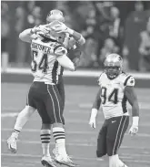  ?? BRETT DAVIS/USA TODAY SPORTS ?? New England defenders celebrate after sacking Rams quarterbac­k Jared Goff.