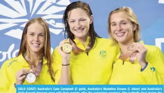  ??  ?? GOLD COAST: Australia’s Cate Campbell (C gold), Australia’s Madeline Groves (L silver) and Australia’s Holly Barratt (bronze) pose with their medals after the swimming women’s 50m butterfly final during the 2018 Gold Coast Commonweal­th Games at the...