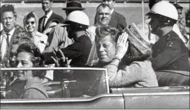  ?? JIM ALTGENS / AP 1963 ?? President John F. Kennedy waves from his car about a minute before he was shot in Dallas on Nov. 22, 1963. The National Archives has until Oct. 26 to release the remaining files on the assassinat­ion, unless President Donald Trump intervenes.