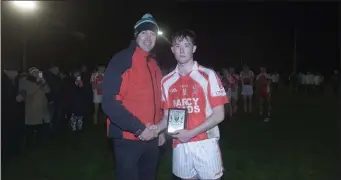  ??  ?? Tinahely’s Matthew Ging collects the Wicklow People Man of the Match award.