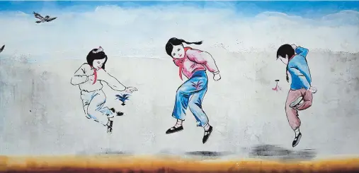  ??  ?? A wall painting about girls playing a kick game, long before computer games — All photos by Wang Yong