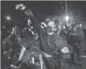  ?? PAULA BRONSTEIN/AP ?? Protesters throw eggs at local police during the nightly protests at a Portland, Ore., police precinct Sunday.