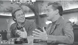  ??  ?? Cliff (Brad Pitt, left) and Rick (Leonardo DiCaprio) are friends in “Once Upon a Time ... in Hollywood.”