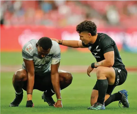  ?? Photo: World Rugby ?? An emotional Fiji Airways Fiji men’s rugby sevens prop Joseva Talacolo is being consoled by New Zealand sevens player Tepaea Savage at the National Stadium in Kallang, Singapore on April 9, 2023.