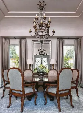  ?? Photos by Michael Hunter ?? An extra-long antique Italian chandelier with 18 arms hangs over the dining table.