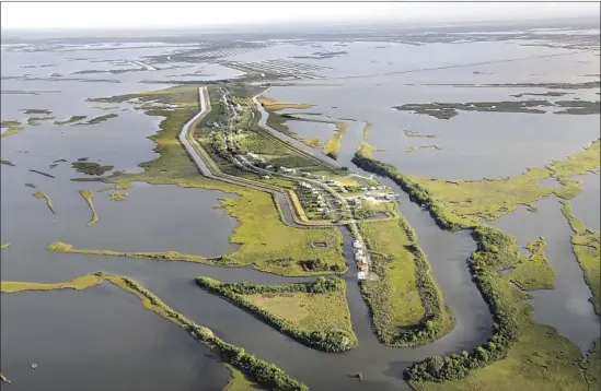  ?? Photograph­s by Carolyn Cole Los Angeles Times ?? IN THE LAST six decades, more than 98% of Isle de Jean Charles, La., has slipped into the Gulf of Mexico. About 40 residents remain, down from a peak of over 300.