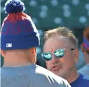  ?? DAVID BANKS/AP ?? Cubs manager Joe Maddon, right, and Kyle Schwarber talk during practice at Wrigley Field on Sunday.