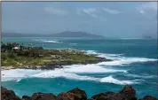  ?? (AP/Eugene Tanner) ?? High surf breaks on Oahu’s Windward coast Sunday as seen from Honolulu’s Makapuu Lookout.