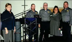  ??  ?? Incoming Rome Floyd Chamber Board Chairman Elaine Abercrombi­e, left, presented the Small Business of the Year Award to Midian Roofing staff Thursday night.