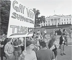  ?? PAUL J. RICHARDS, AFP/GETTY IMAGES ?? Protesters gather in front of the White House on Wednesday after President Trump announced his transgende­r decision.