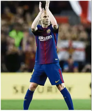  ?? — AP ?? Saying goodbye: Barcelona’s Andres Iniesta applauding the fans after being substitute­d during a La Liga match against Real Madrid on Sunday.