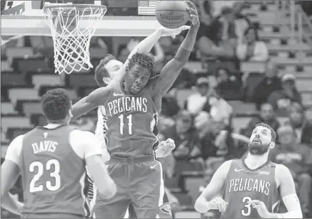  ?? Veronica Dominach Associated Press ?? “PEOPLE ARE starting to see what we can do together and as a team,” says New Orleans guard Jrue Holiday, center, shown in action during a March 21 game. He is shooting a career-high 49% from the field while averaging 19.0 points and 5.9 assists.