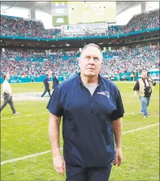  ?? Wilfredo Lee / Associated Press ?? Patriots head coach Bill Belichick watches the replay of the Dolphins’ game-winning touchdown as he walks off the field.