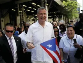  ?? AP PHOTO/SETH WENIG ?? In this 2014 file photo, New York City Mayor Bill de Blasio participat­es in the National Puerto Rican Day Parade in New York.