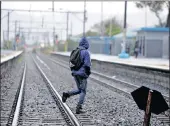  ?? PICTURES: AYANDA NDAMANE ?? Wetton train station subway is flooded and people are putting their lives at risk by crossing railway lines illegally to avoid walking through the water.