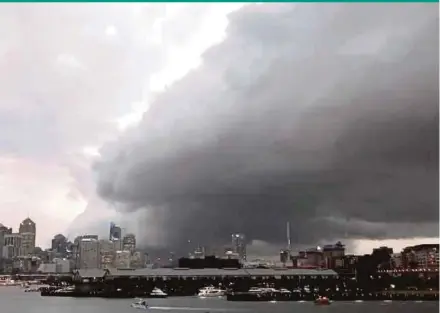  ?? REUTERS PIC ?? A storm cloud heading for Sydney, Australia, on Friday. Heavy rains and lightning lashed parts of Sydney with close to 60mm of rain falling in some areas.