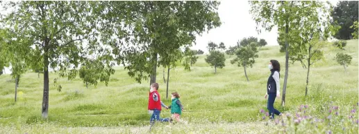  ?? (Sergio Perez/Reuters) ?? MIRIAM DEL PESO and her children Pablo and Sofia are seen in a park in Madrid yesterday after restrictio­ns were partially lifted for children for the first time in six weeks.