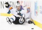  ?? Bruce Bennett / Getty Images ?? The Sharks’ MarcEdouar­d Vlasic checks the Islanders’ Mathew Barzal into the boards during the second period.