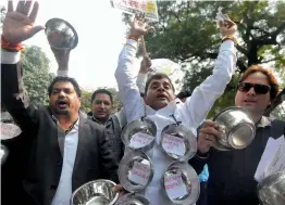 ?? — BIPLAB BANERJEE ?? Traders shout slogans as they take part in a ‘ Katora’ protest in New Delhi on Sunday against the ongoing sealing drive in the city.