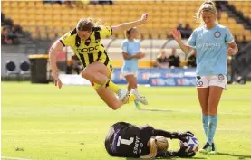  ?? Photo / Photosport ?? Wellington’s Ava Pritchard leaps over City keeper Sally James.