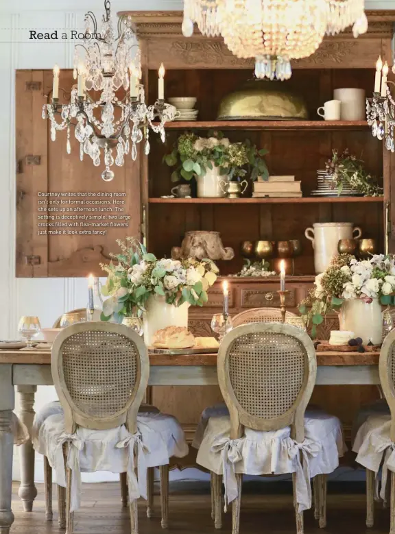  ??  ?? Courtney writes that the dining room isn't only for formal occasions. Here she sets up an afternoon lunch. The setting is deceptivel­y simple: two large crocks filled with flea-market flowers just make it look extra fancy!